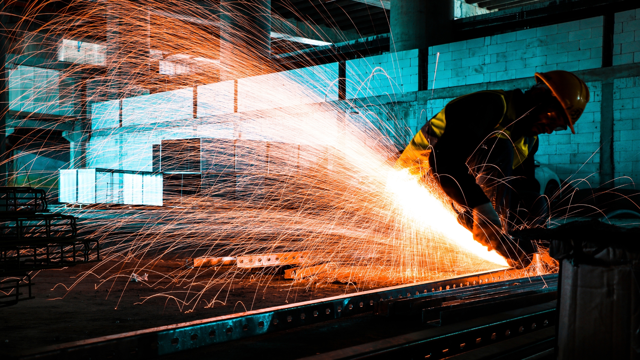 A Worker Cutting Metal