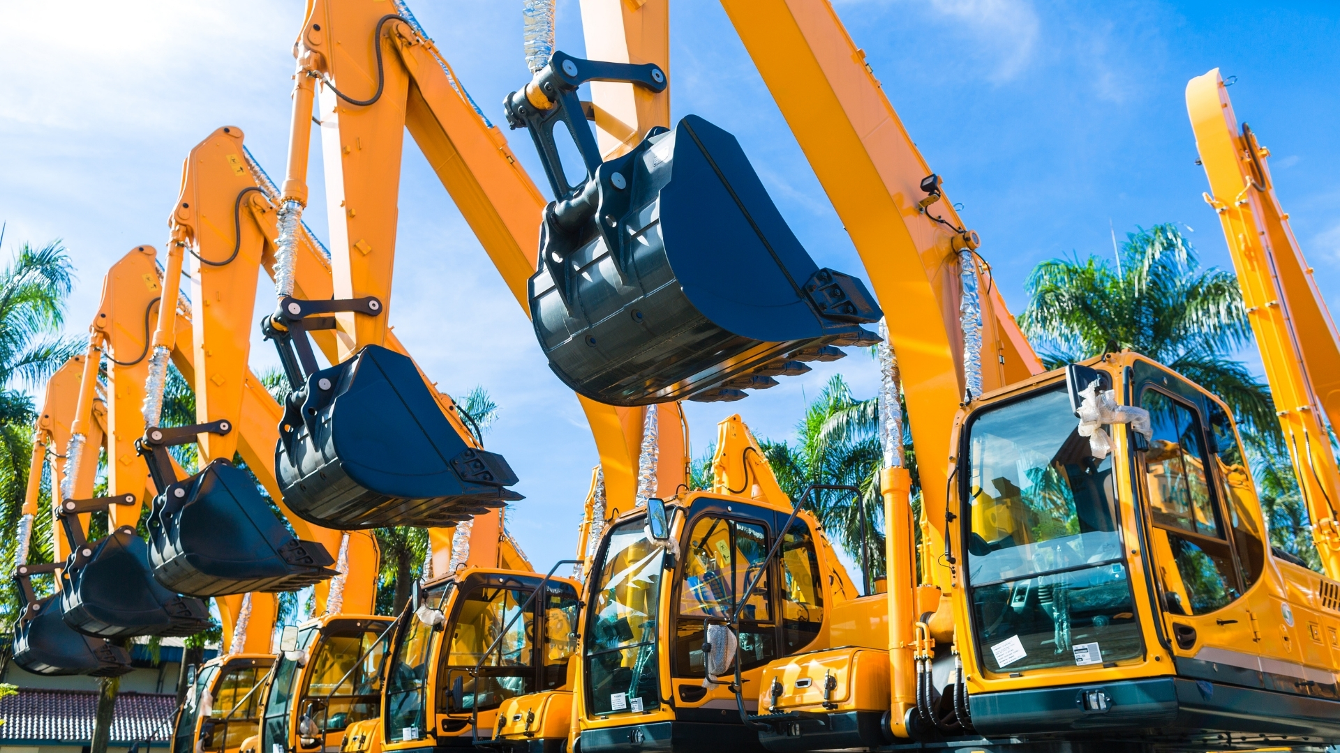 vehicle fleet with construction machinery standing in a row