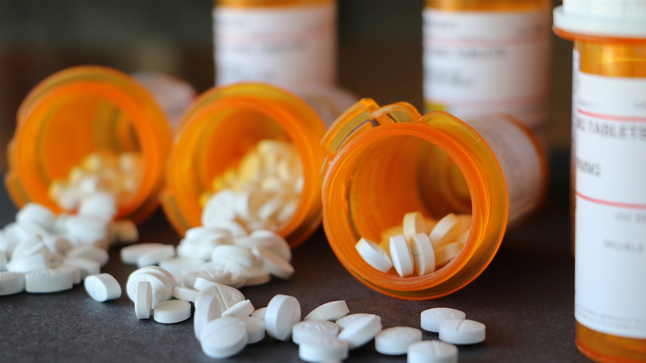 Prescription medication bottles on gray background