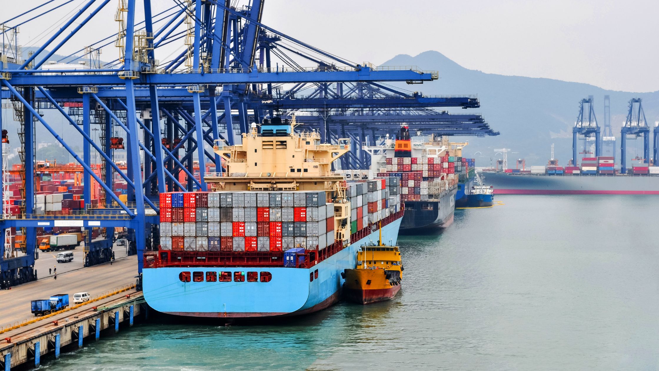 Container ship in port at container terminal Port Shenzhen, China. Ships of container ships stand in terminal of port on loading, unloading container